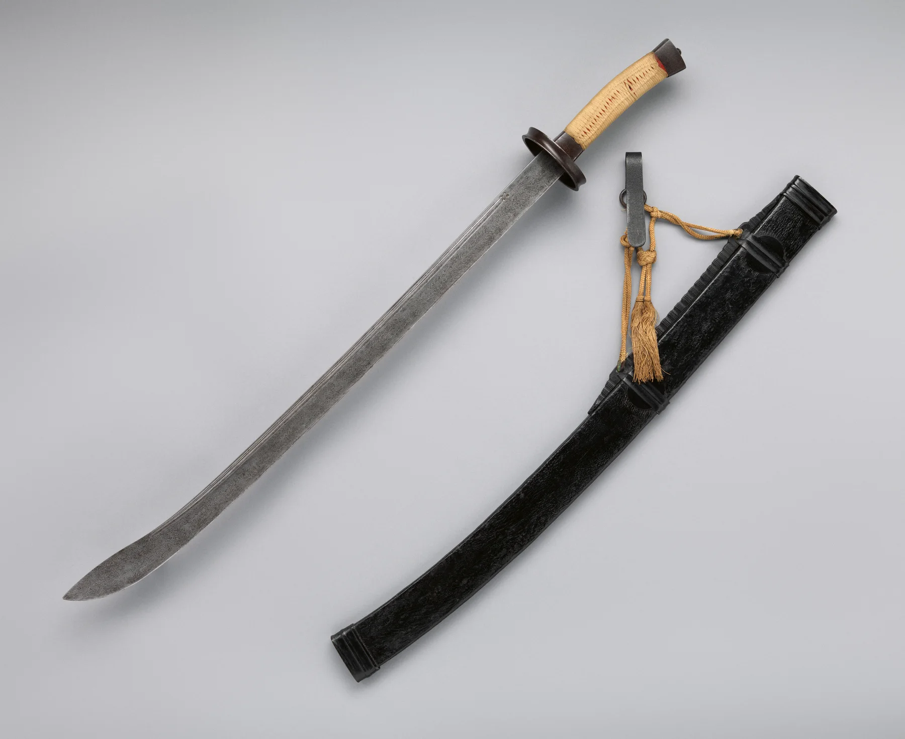 Eighteenth-century Chinese dao saber with a curved patterned blade, scabbard and belt fittings