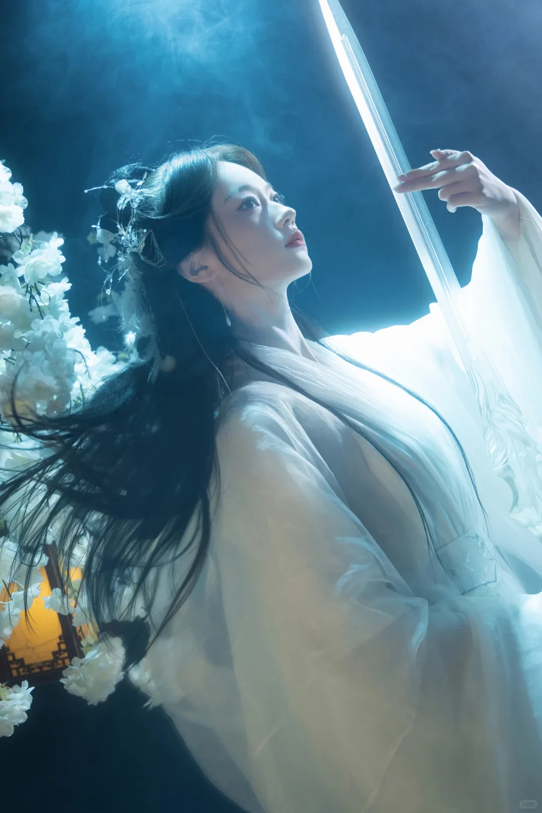 Xianxia vs wuxia shown through a real studio portrait with a sword, blue light and fantasy costume