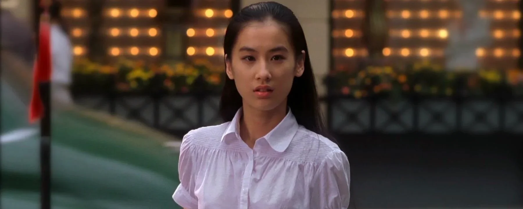 The mute girl faces Sing across the street in the memory that survives his gangster performance