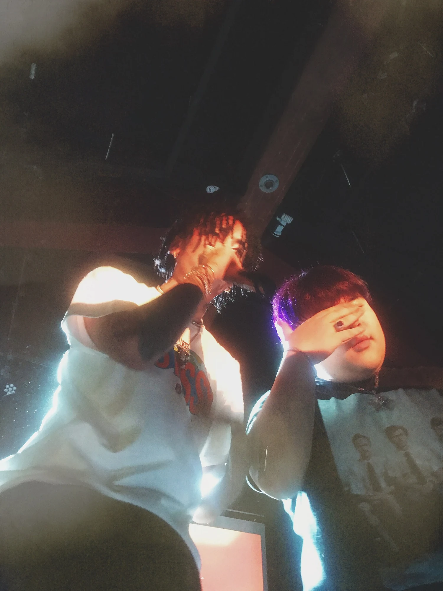 Two Higher Brothers members performing at close range during a 2018 concert