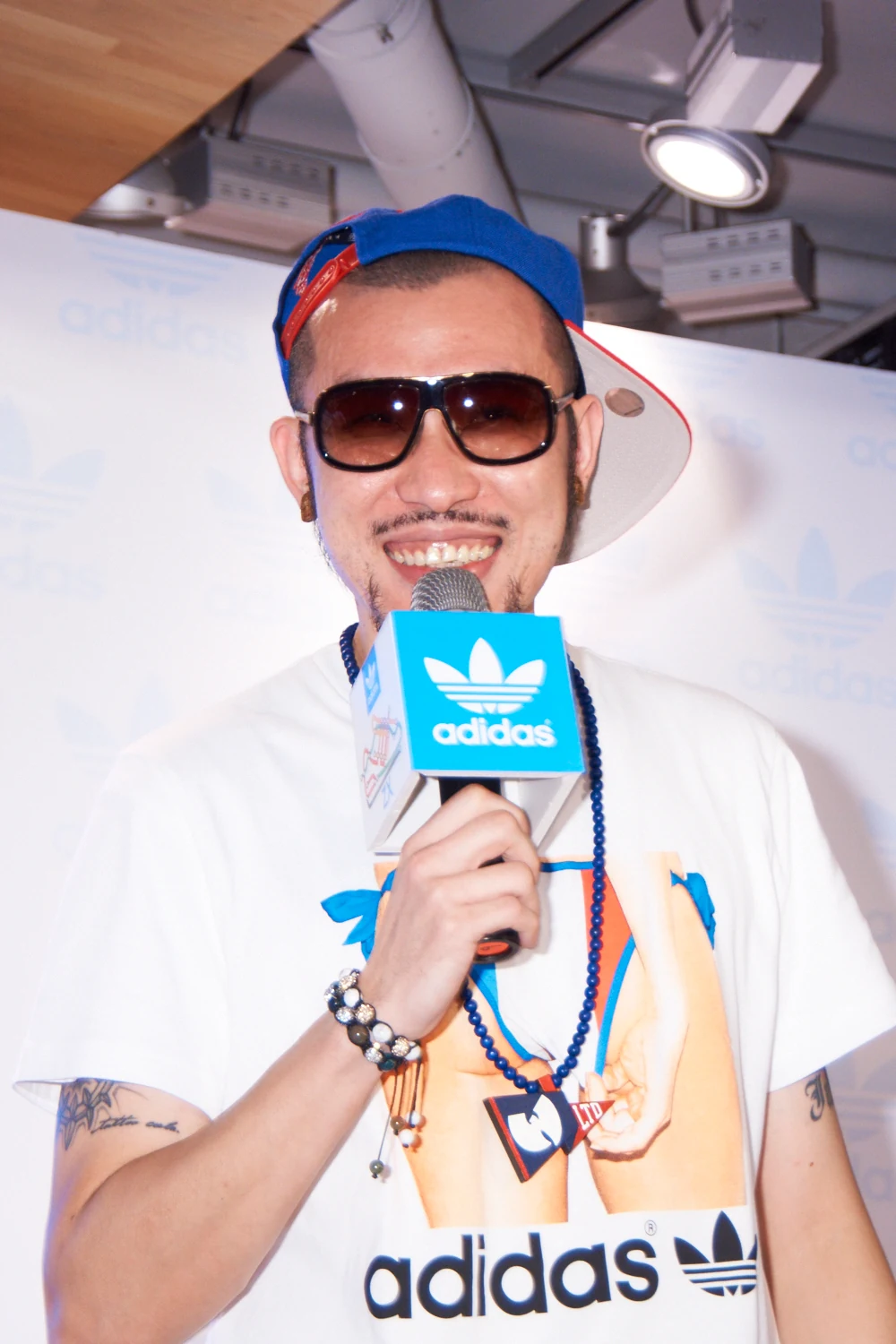 MC HotDog holding a branded microphone at a 2012 public event