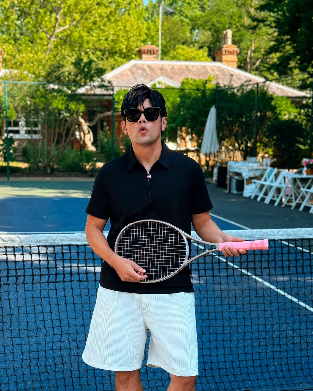 Jay Chou with a tennis racket on an outdoor court