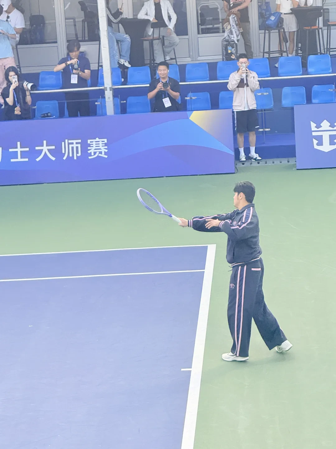 Jay Chou holding a tennis racket during a Shanghai Masters appearance