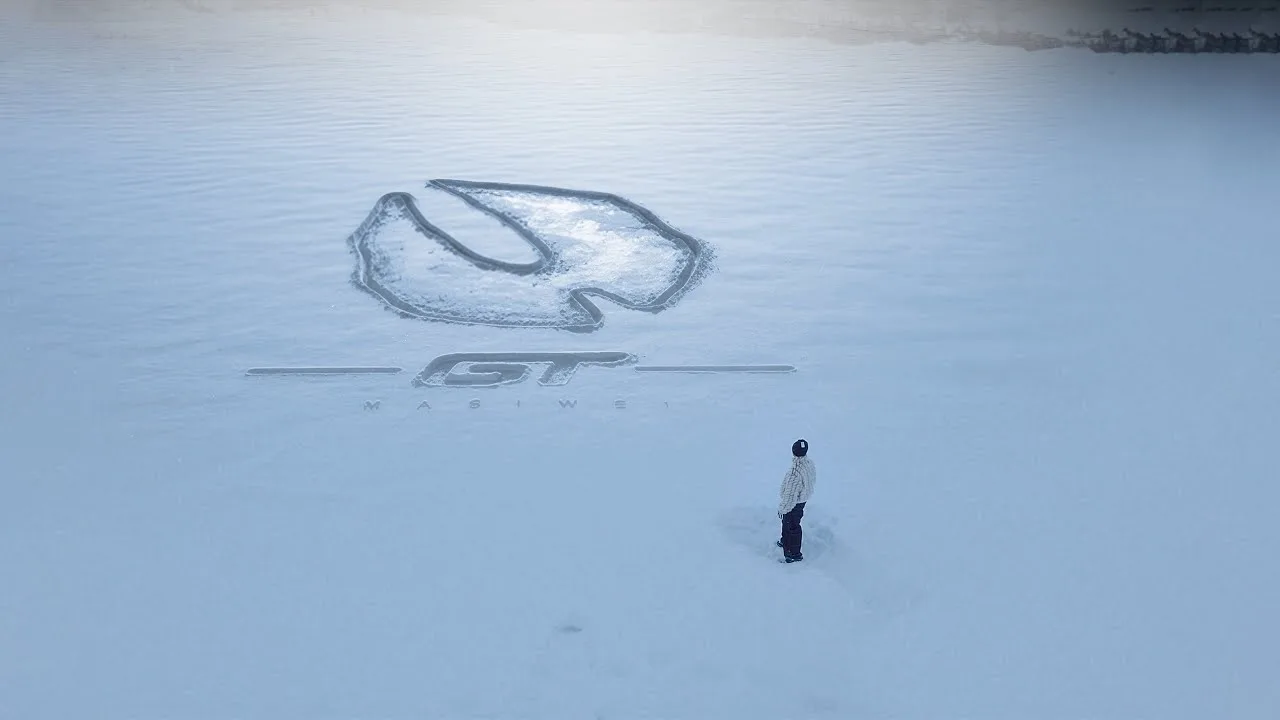 Small figure of Masiwei standing in a vast white landscape in the T0 official music video