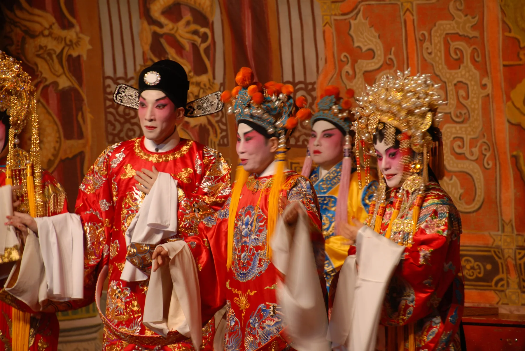 A full Cantonese Opera stage in Hong Kong with several performers before a painted setting