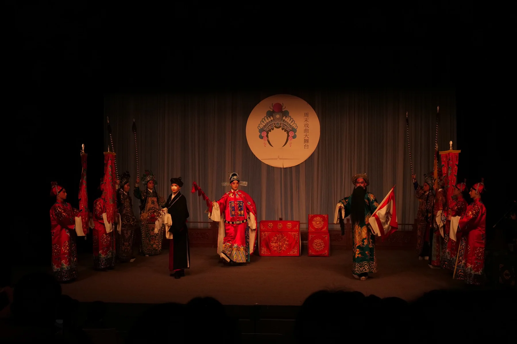 Several Kunqu performers holding a formal stage relationship inside Hangzhou Grand Theatre