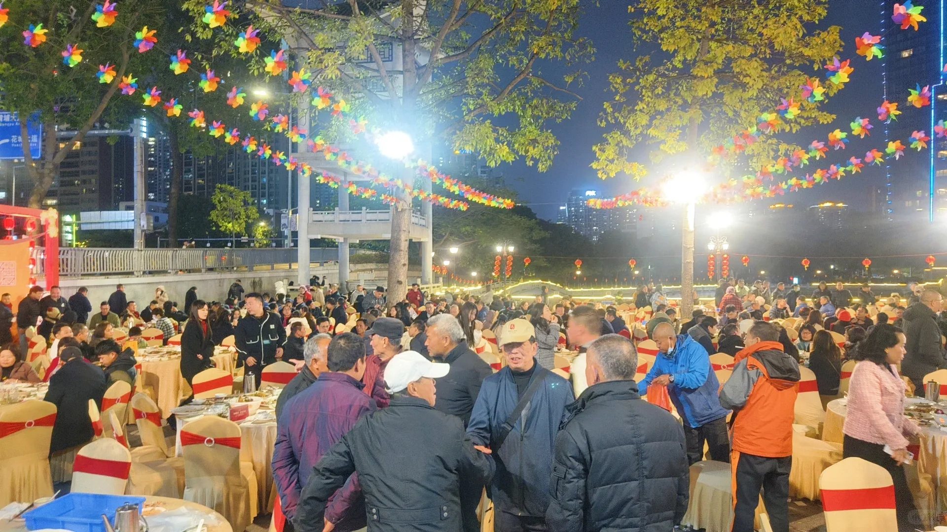 A large clan New Year banquet held outdoors beside a Guangzhou ancestral hall