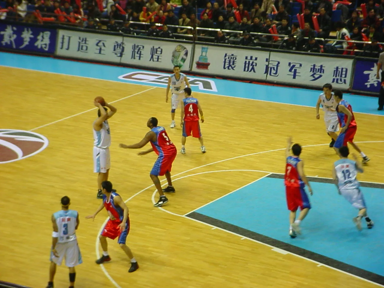 Beijing Ducks and Xinjiang players occupy a half court during a 2006 CBA game