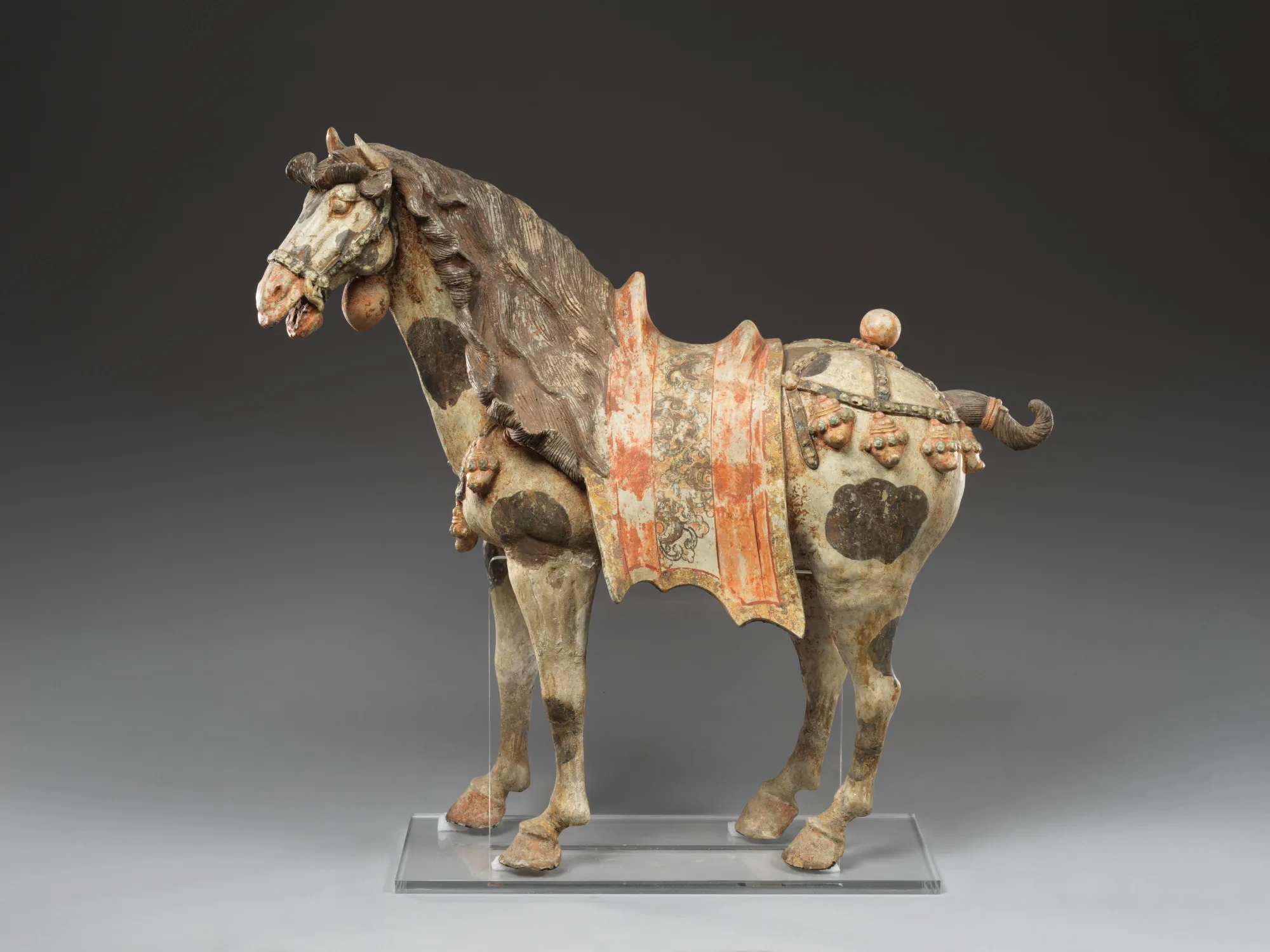 Year of the Horse art comparison: Tang earthenware horse with pigment gilding and harness