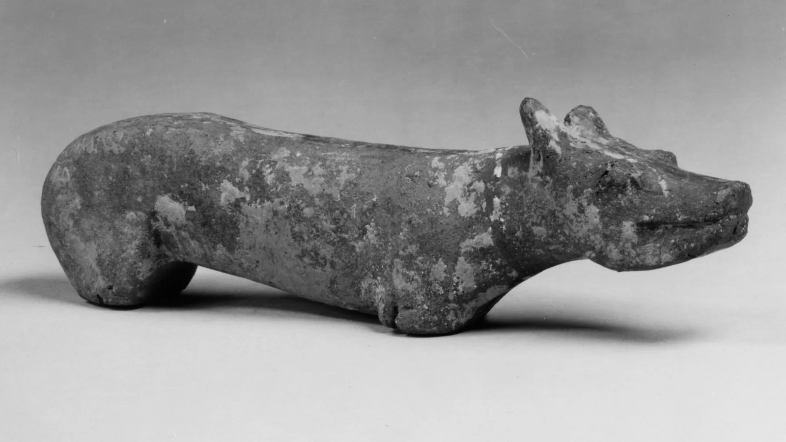 Fifth- to sixth-century Chinese earthenware dog figure with traces of pigment