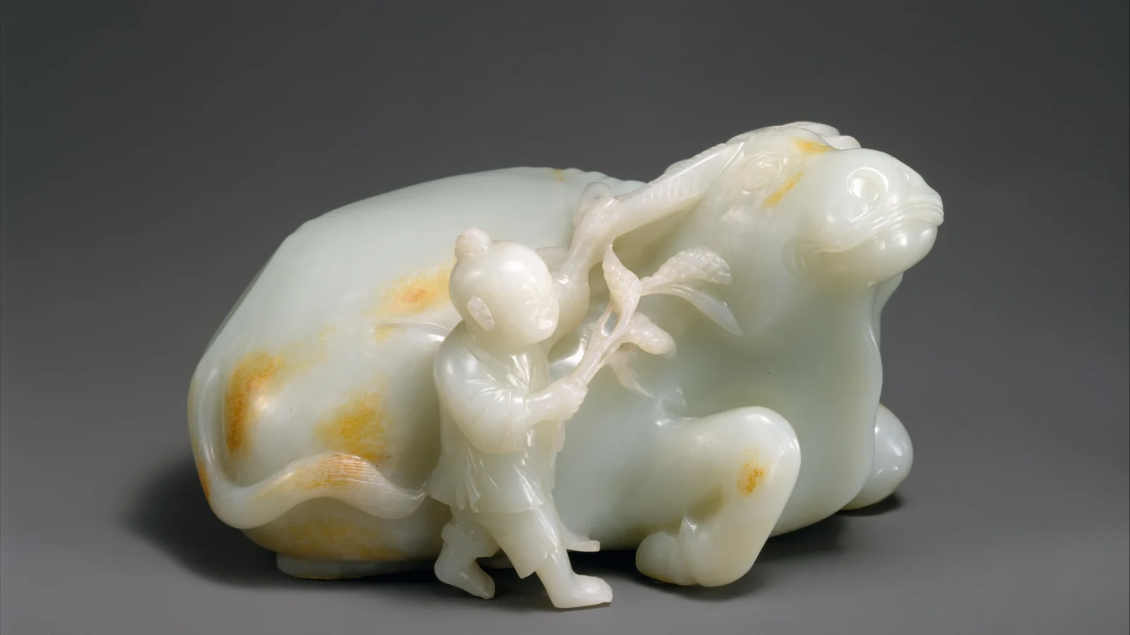 Eighteenth-century jade boy leaning against a resting water buffalo
