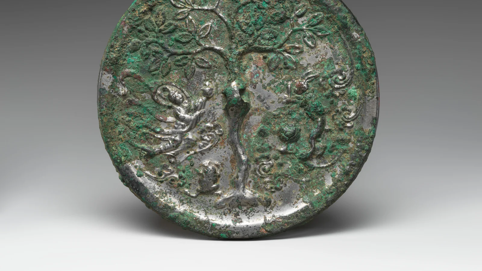An eighth- or ninth-century bronze mirror with a moon goddess and rabbit arranged inside a circular field