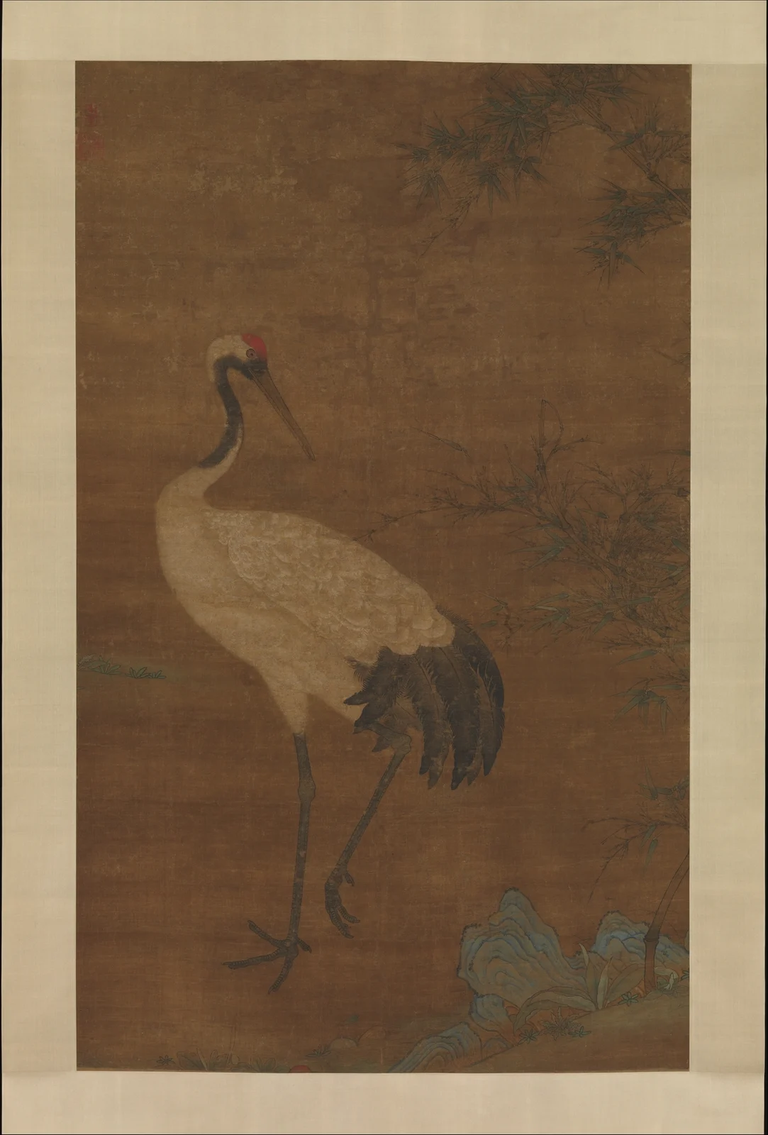 A red-crowned crane turning beneath bamboo in a late Yuan or early Ming Chinese hanging scroll