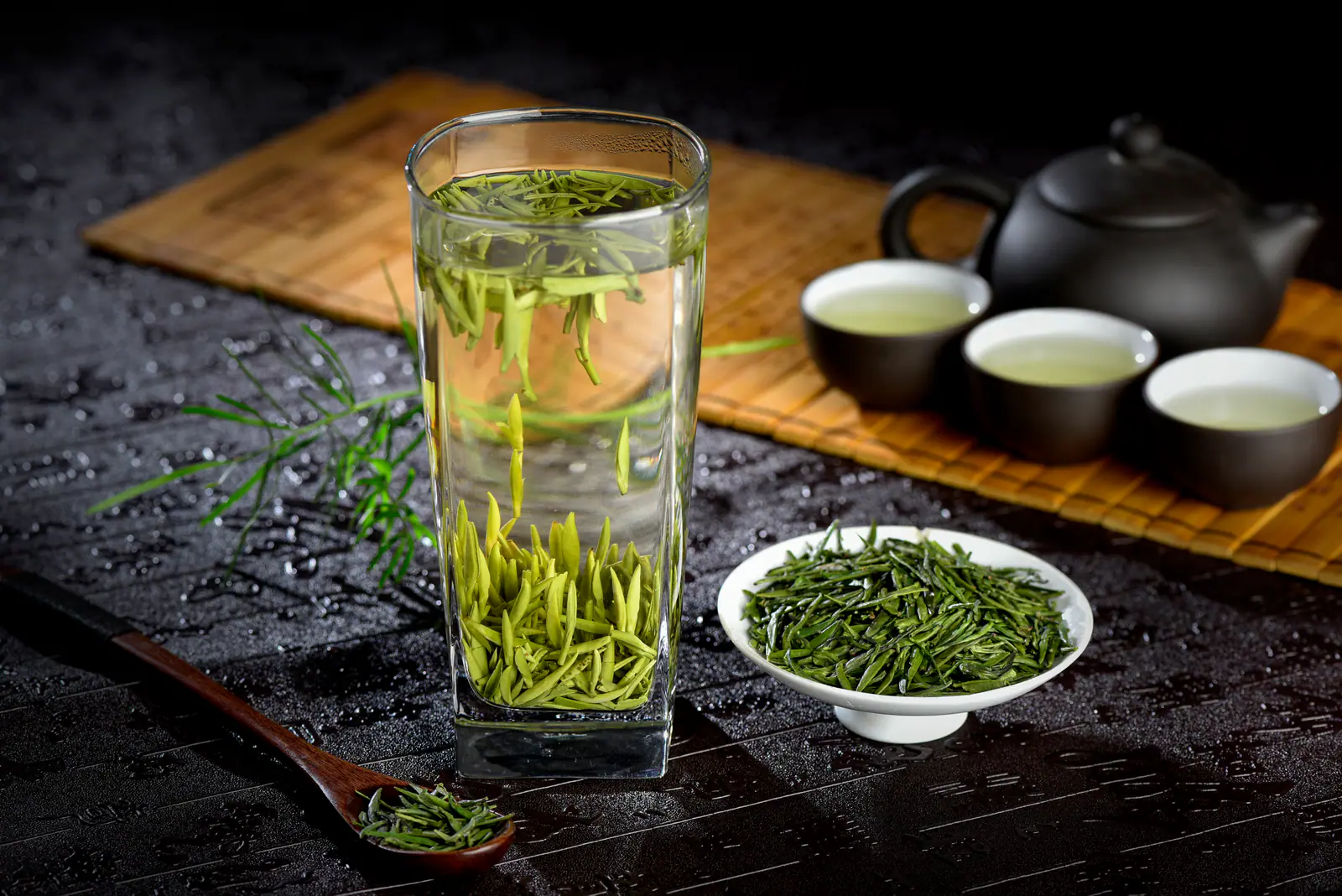 Green tea opening in a clear glass, showing why visible brewing suits fine Biluochun leaf