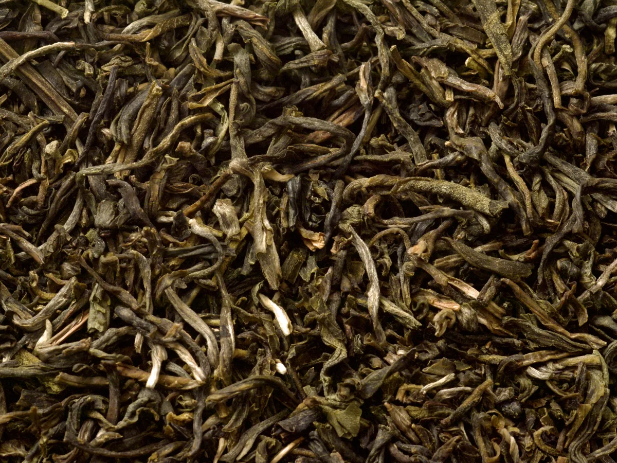 Loose jasmine-scented tea showing the tea base beneath the floral aroma claim