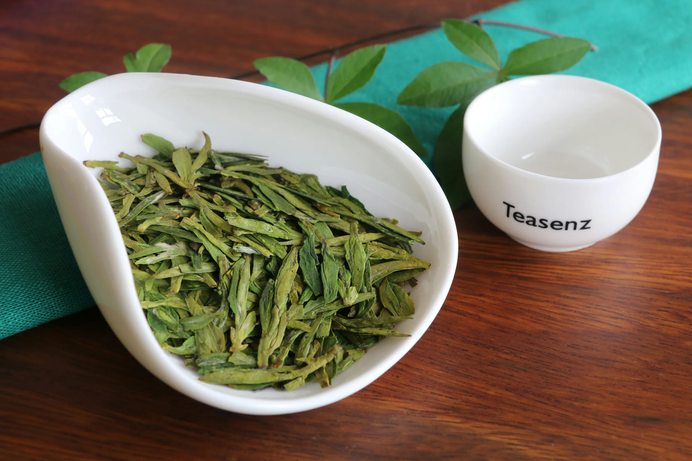 Tea leaves and cups arranged on a tea table for general brewing context