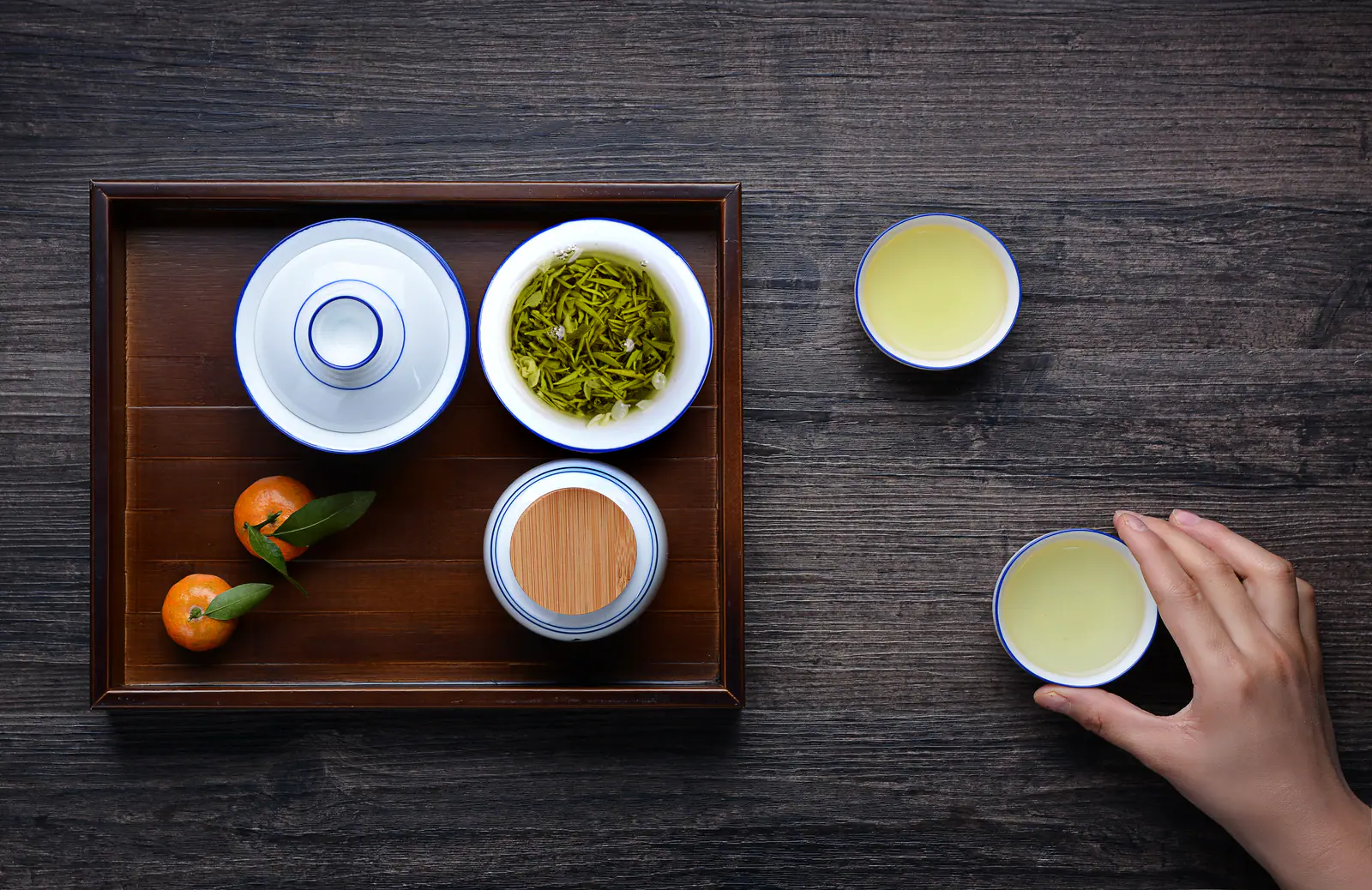 Green tea leaves expanding in clear glassware during an everyday infusion