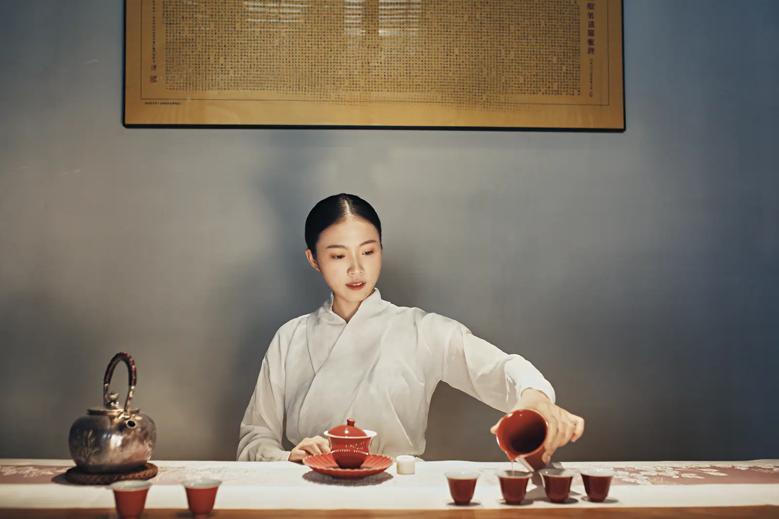 Tea served across several small cups, showing gongfu tea as shared attention