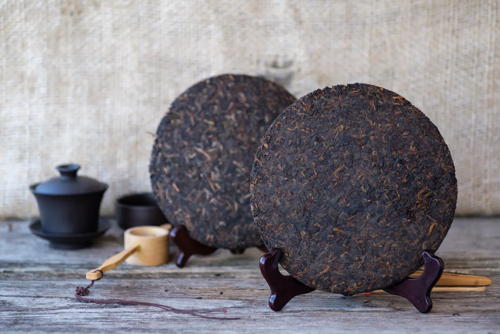 Several stored Pu-erh tea cakes showing compressed tea as a product whose wrapper and storage history both matter