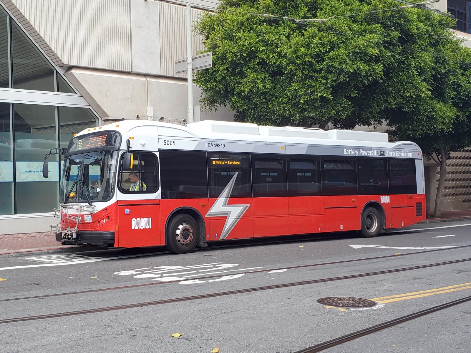 BYD K9 electric bus on a San Francisco Muni route in 2025, showing BYD's US commercial-vehicle presence but not BYD passenger-car retail availability