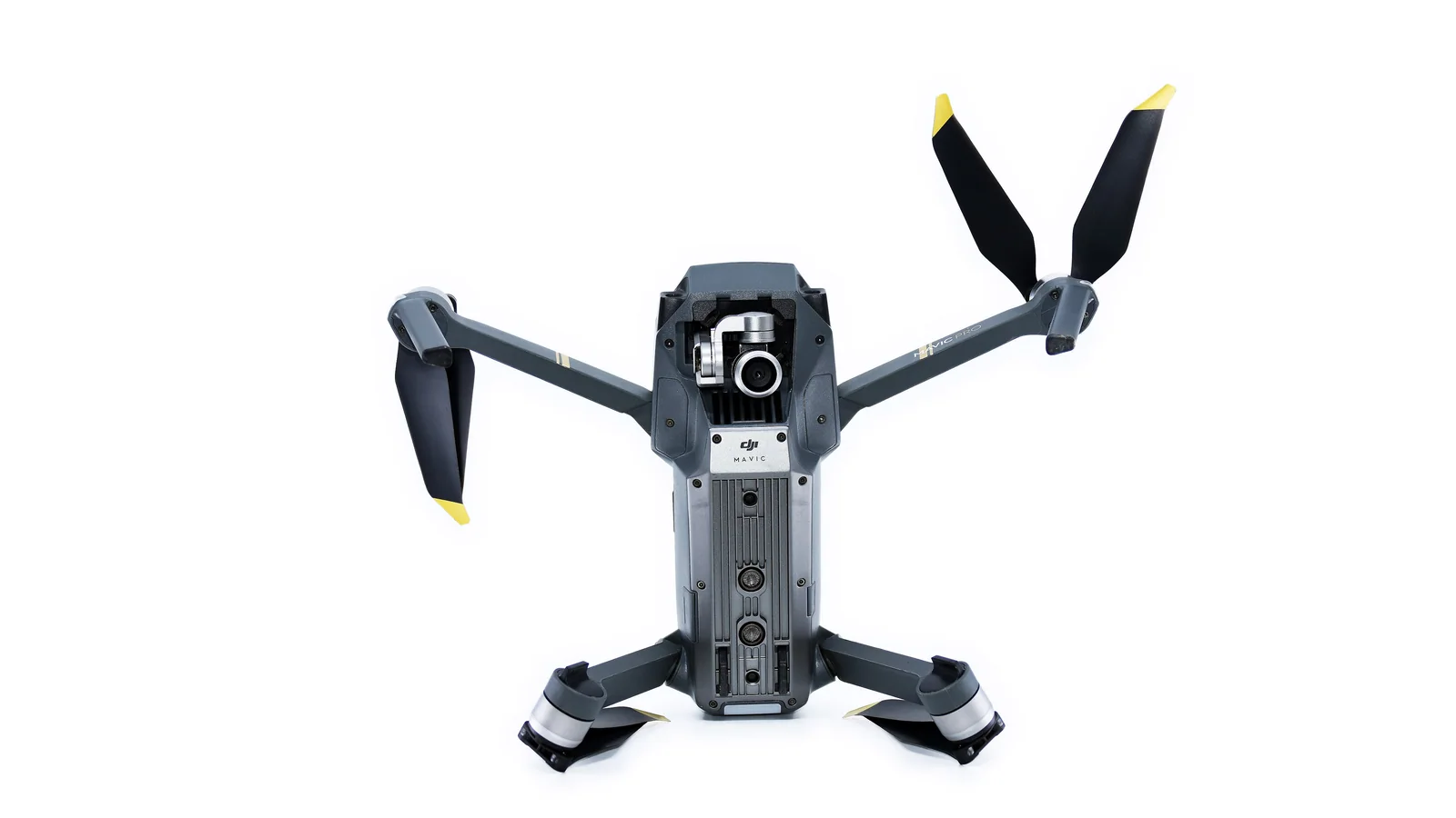 A DJI Mavic Pro photographed from below with the camera, sensors, arms and propellers visible