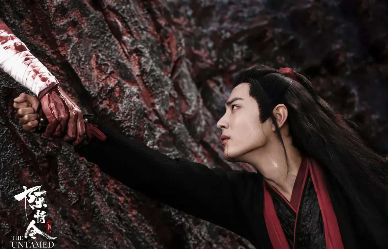 Wei Wuxian reaching toward a bloodied hand in The Untamed