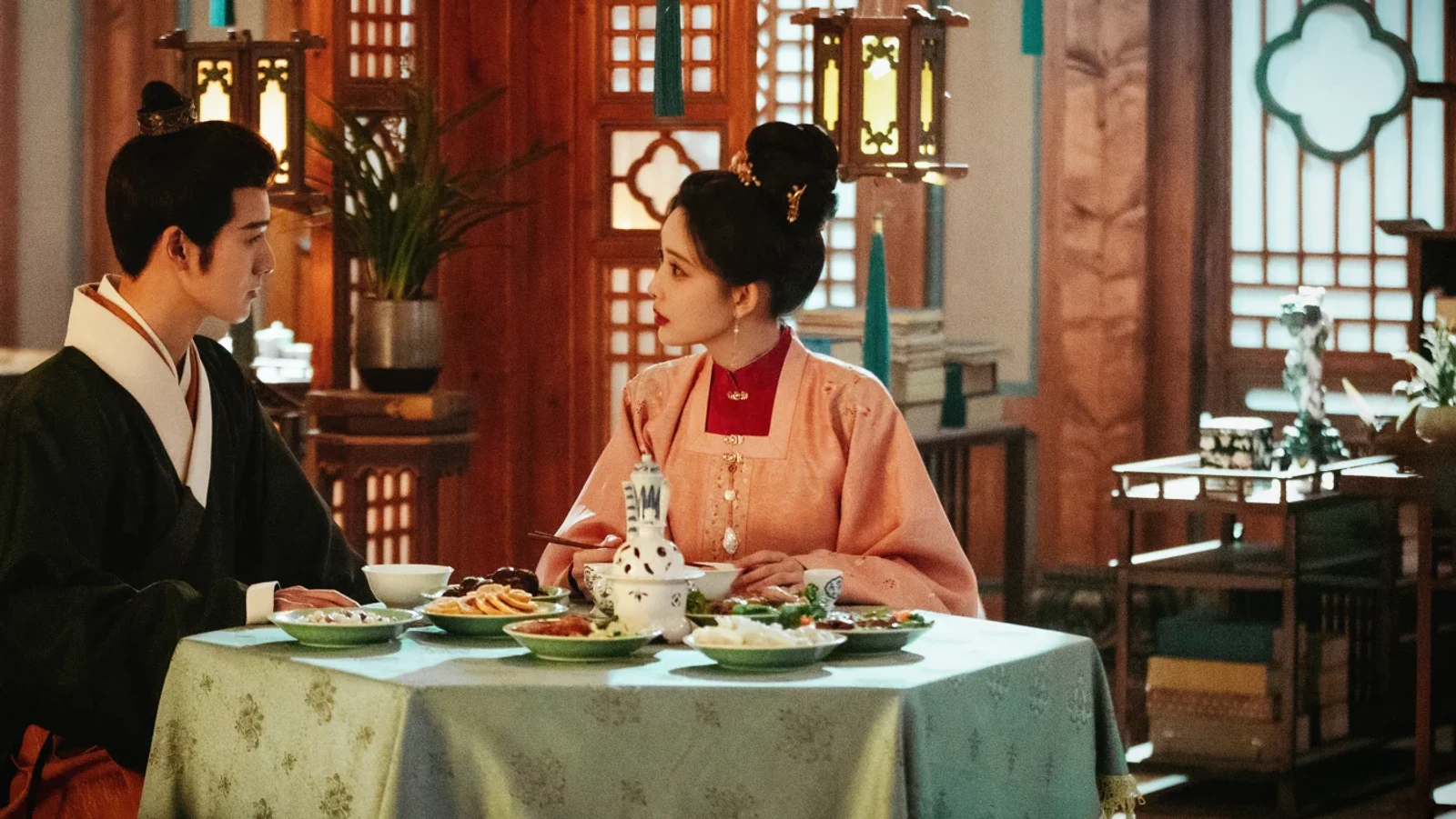 Dou Zhao and Song Mo facing one another across a dinner table in Blossom Chinese drama