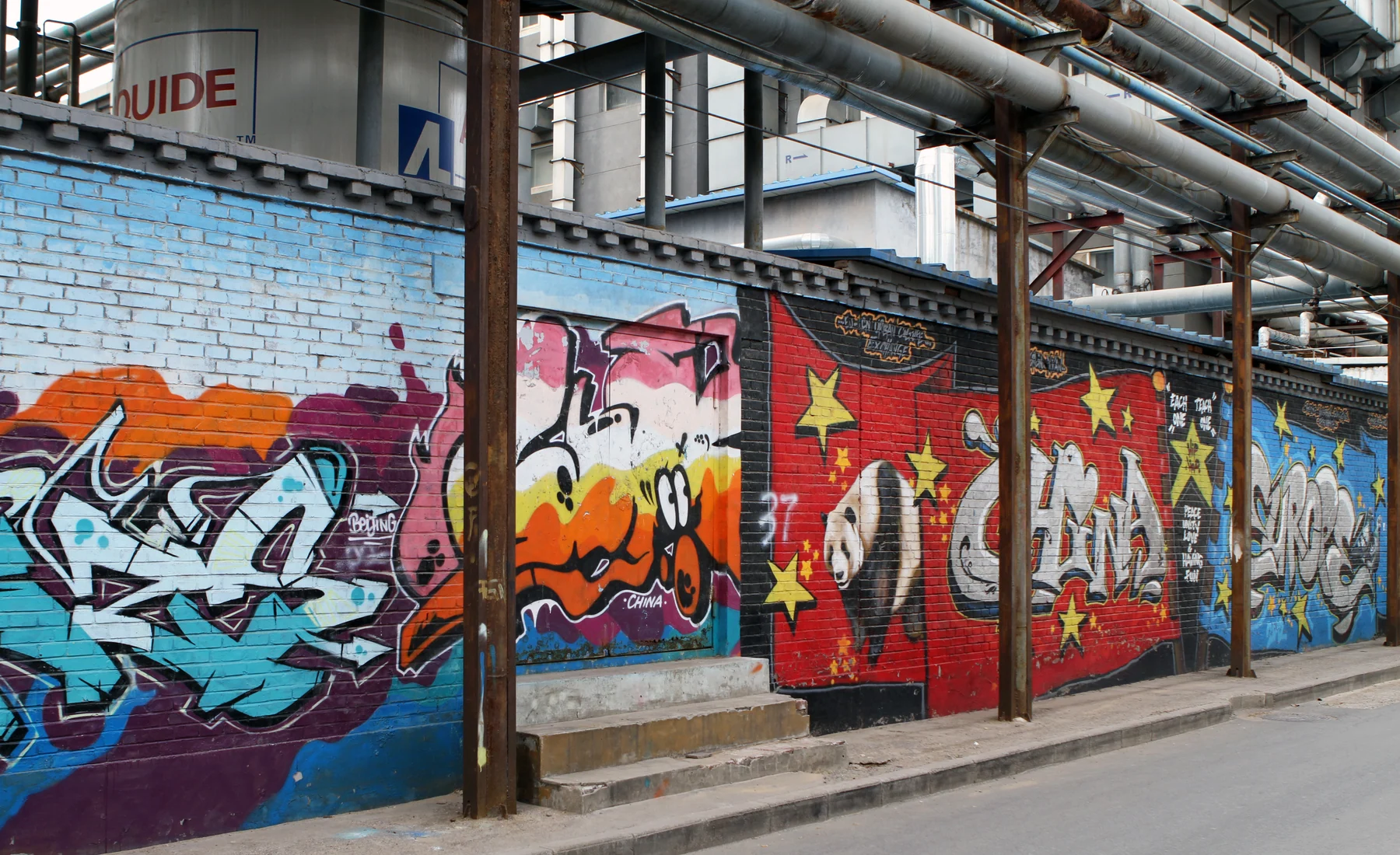 Graffiti held inside exposed industrial infrastructure at Beijing's 798 Art District
