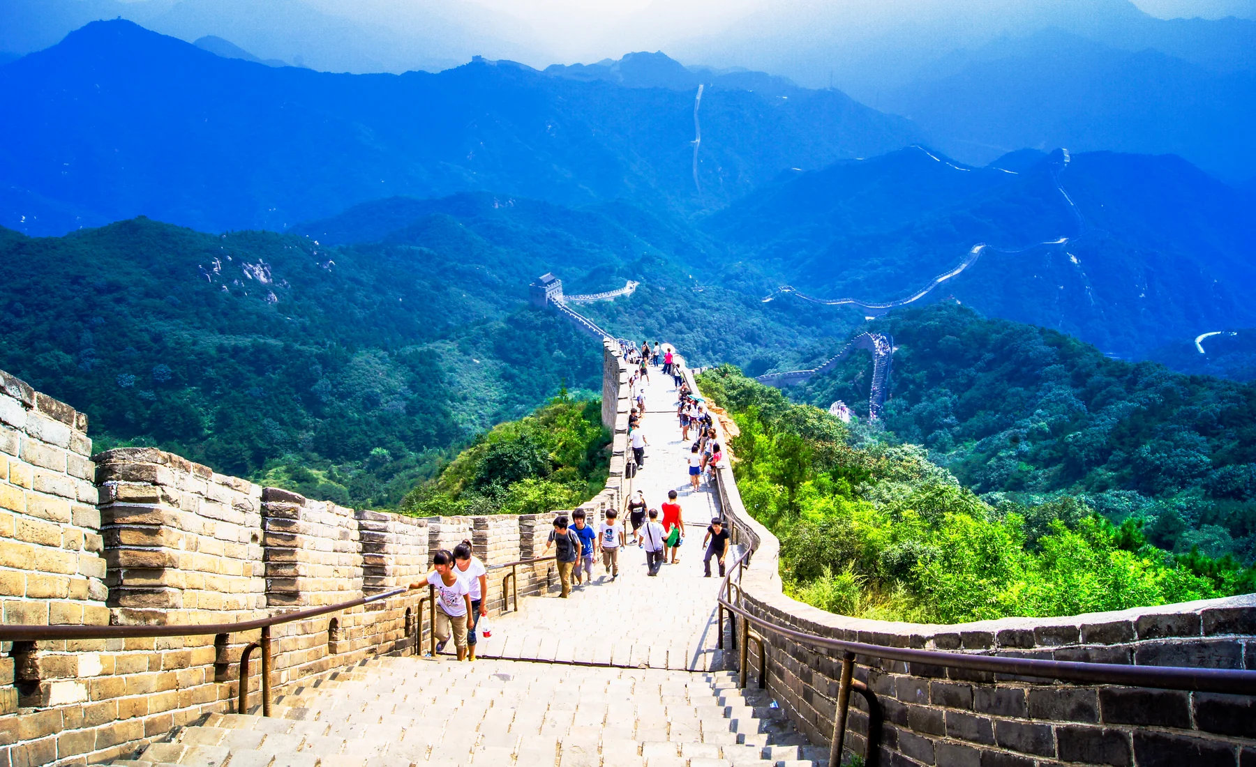 Visitors walking a restored Great Wall ridge, where gradient, exposure and return distance matter more than the postcard view