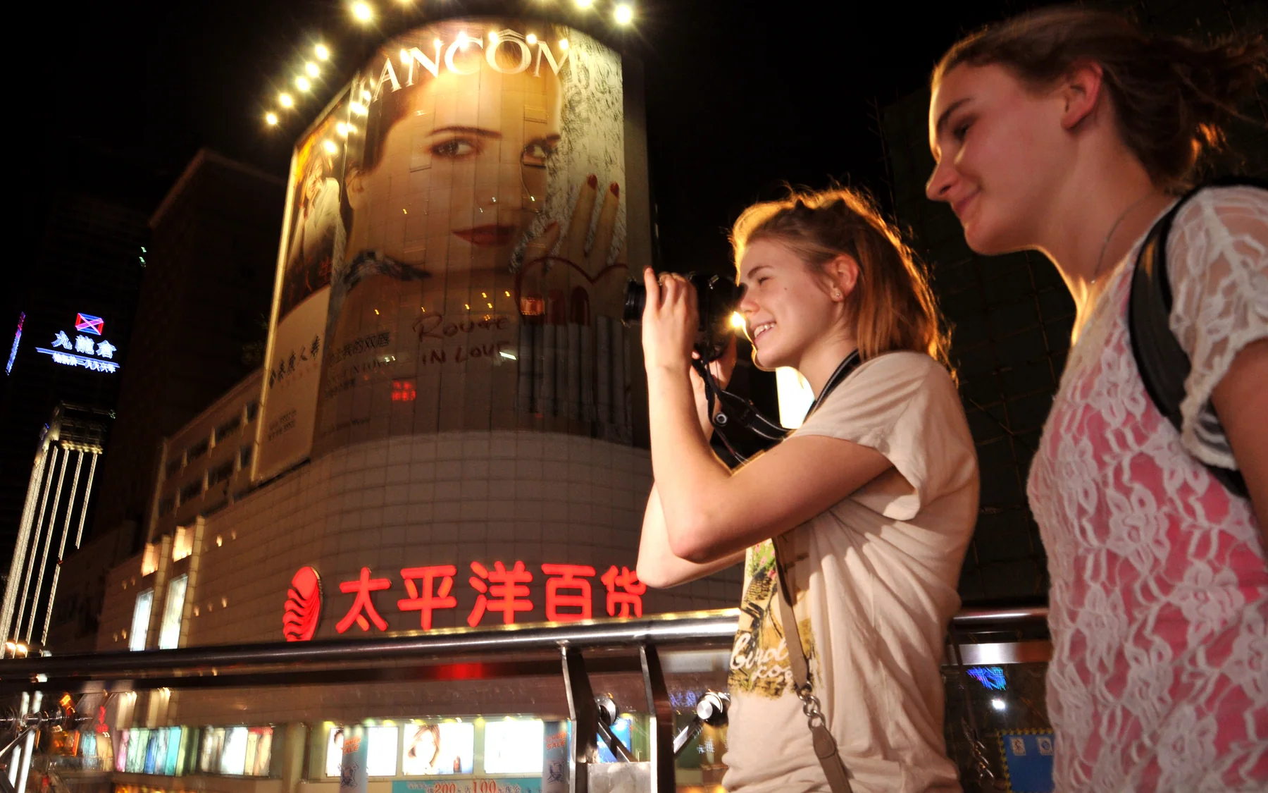 Visitors reading the scale and nightlife of Chunxi Road while planning a central Chengdu route