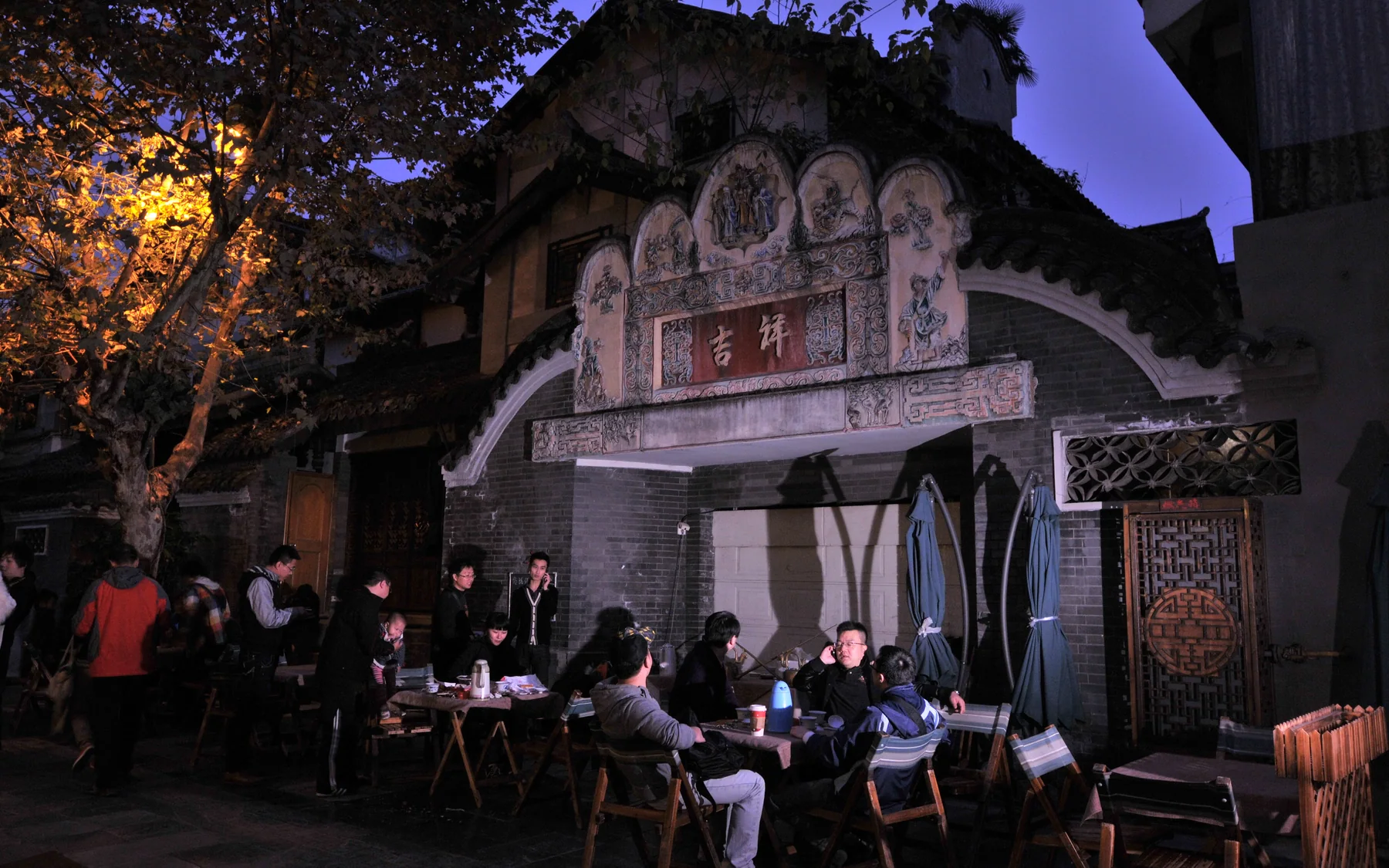 An open-air tea stop in Kuanzhai where travelers can judge shade, seating and pace