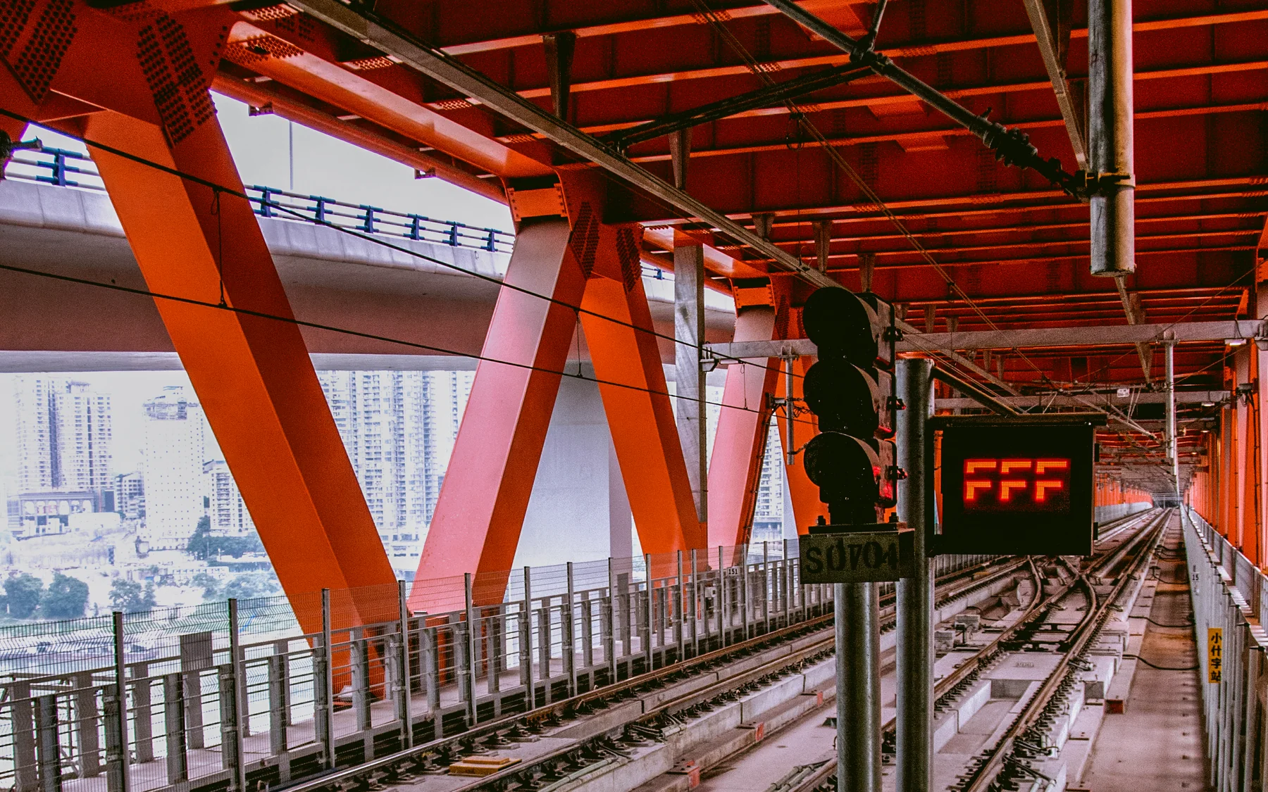 An elevated Chongqing rail line showing transport threaded through dense urban levels