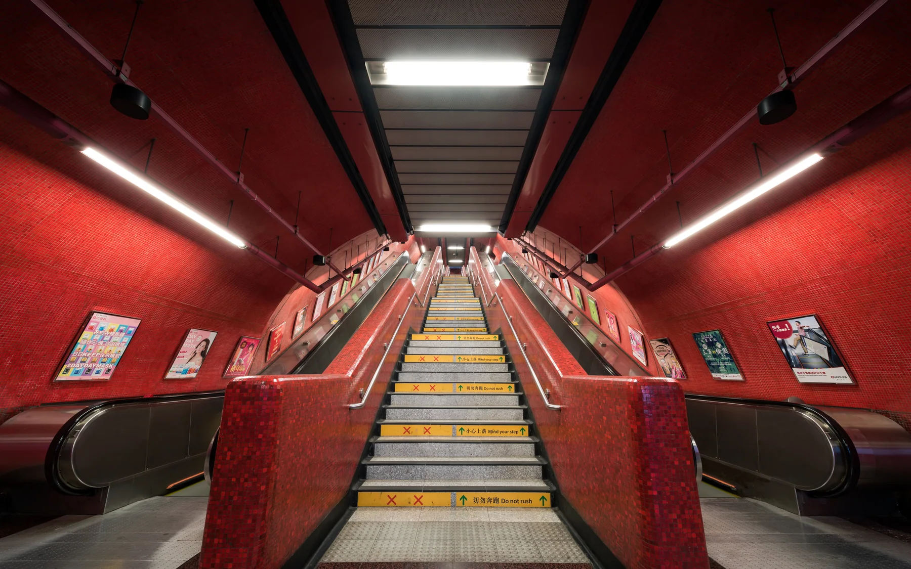 The red escalator hall at Taikoo MTR station, showing how underground movement changes Hong Kong's sense of level
