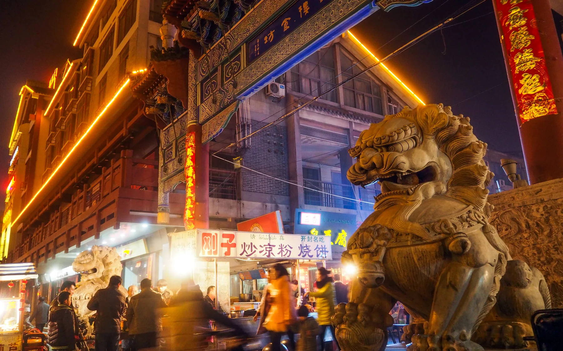 Kaifeng old street at night showing the pedestrian scale of an evening arrival