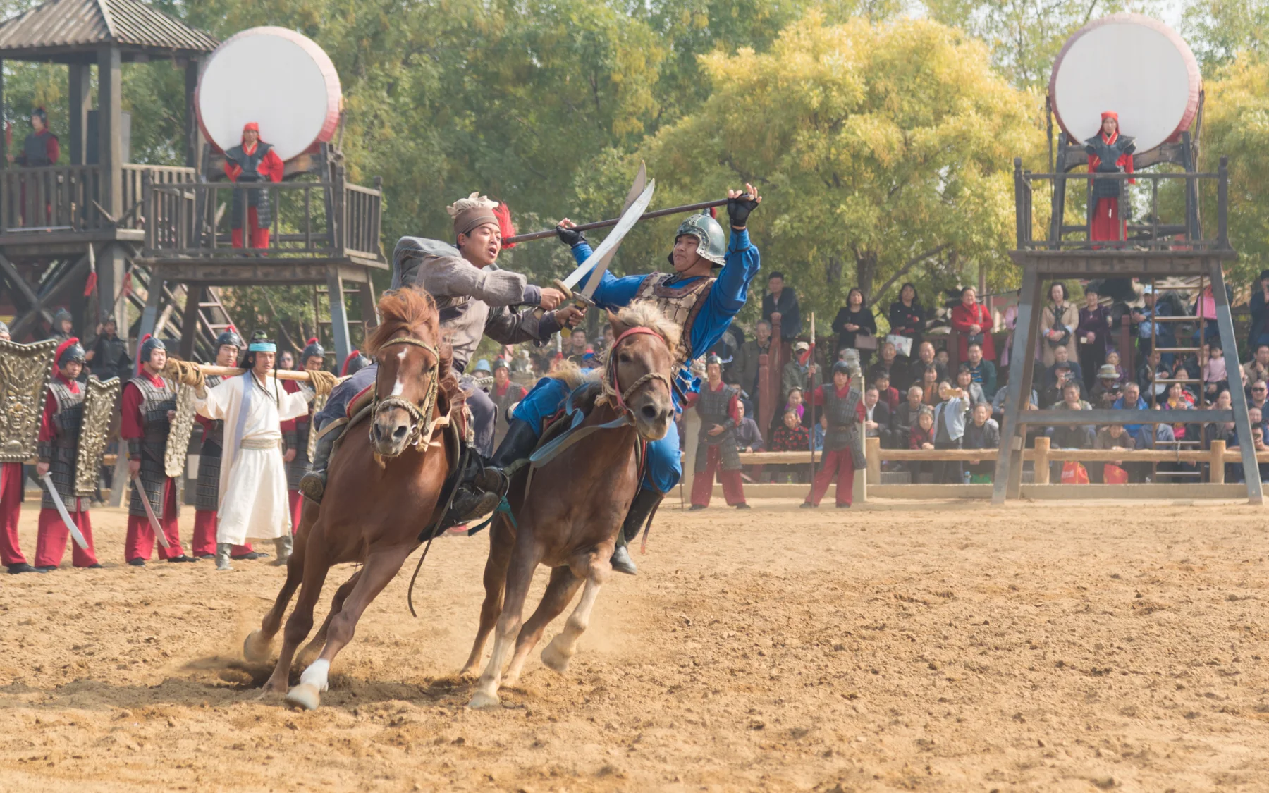 A large horse performance showing the time and crowd commitment of the themed park