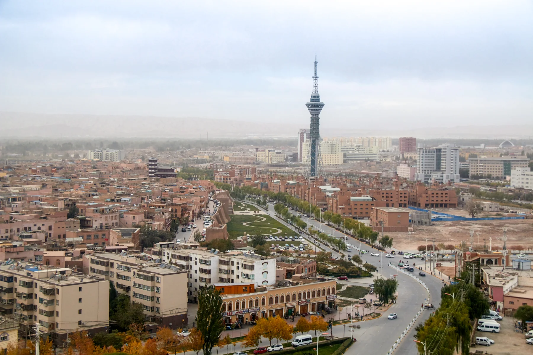 Panoramic view of Kashgar showing old-city roofs, newer buildings and the wider oasis edge