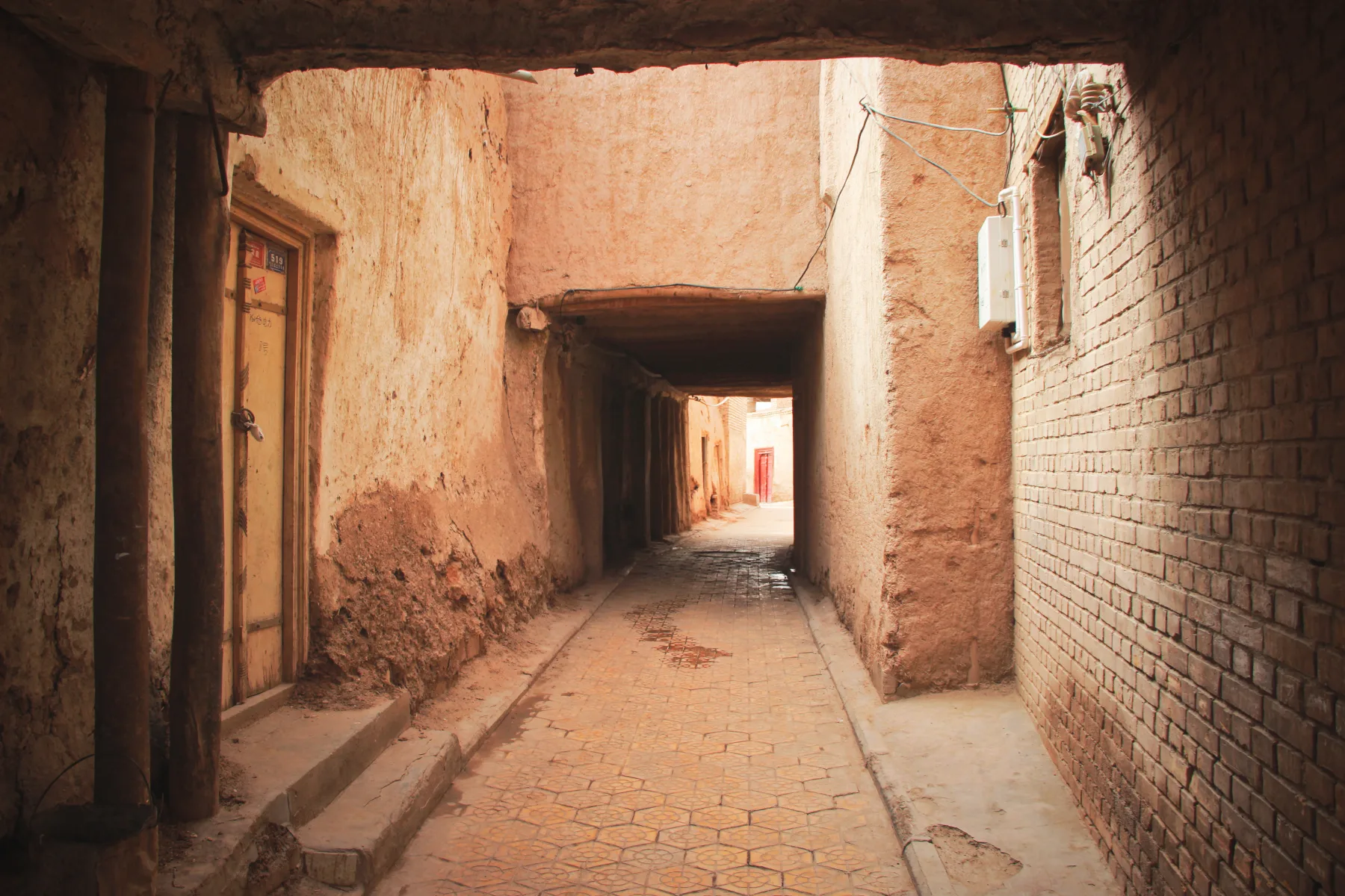 A covered passage and residential lane in Kashgar's old-city area