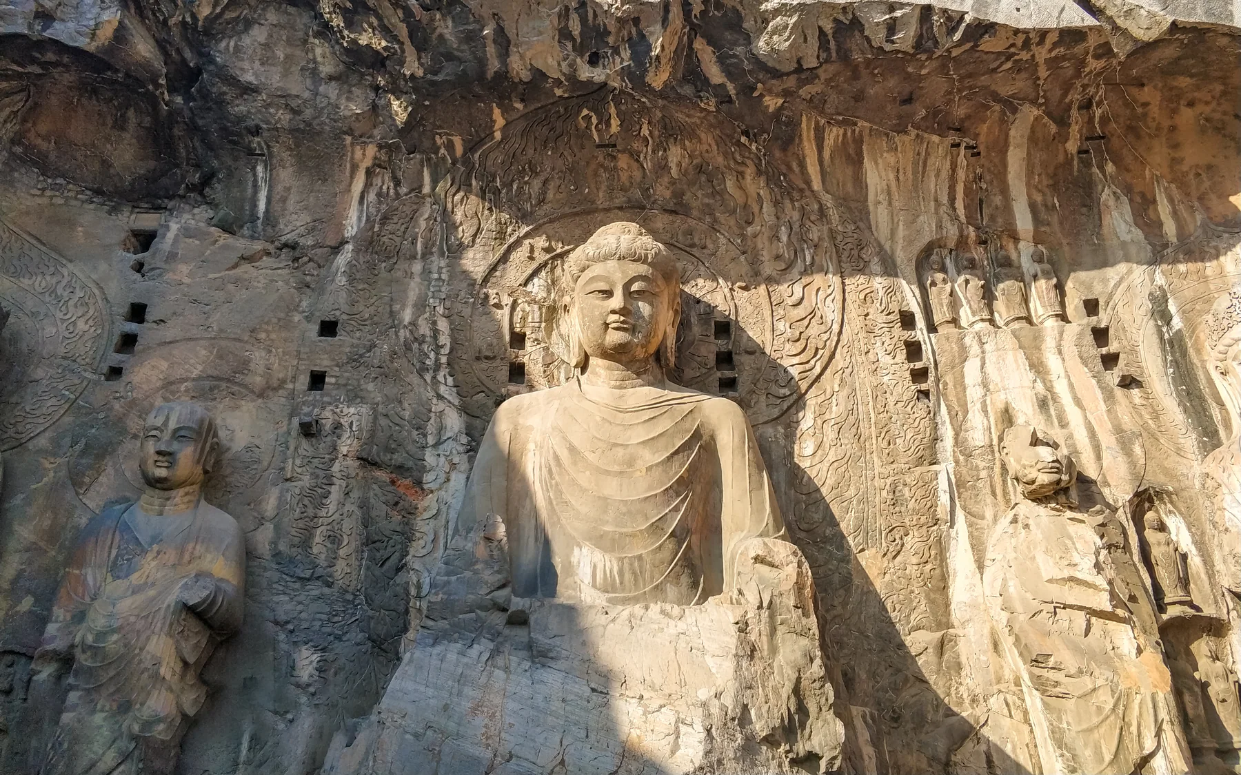 A Longmen Buddhist figure detail that rewards close viewing after the wide approach