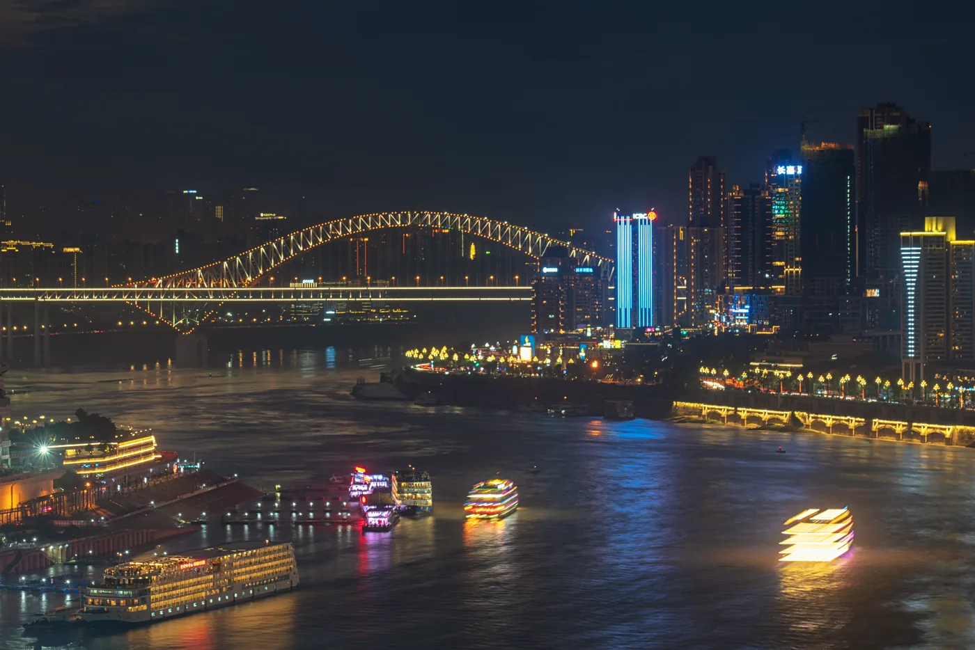 Chongqing river traffic, bridge and contemporary skyline at night