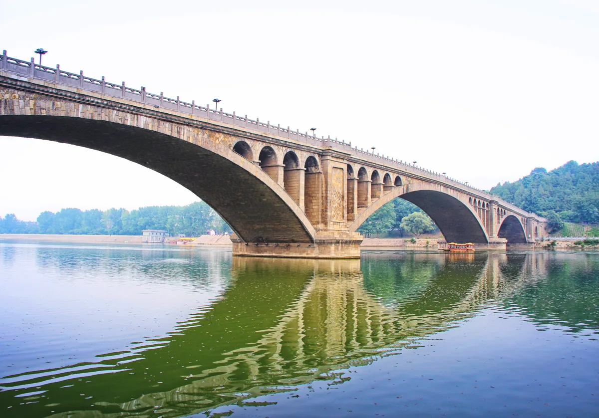 Longmen Grottoes beside the Yi River during travel to Luoyang