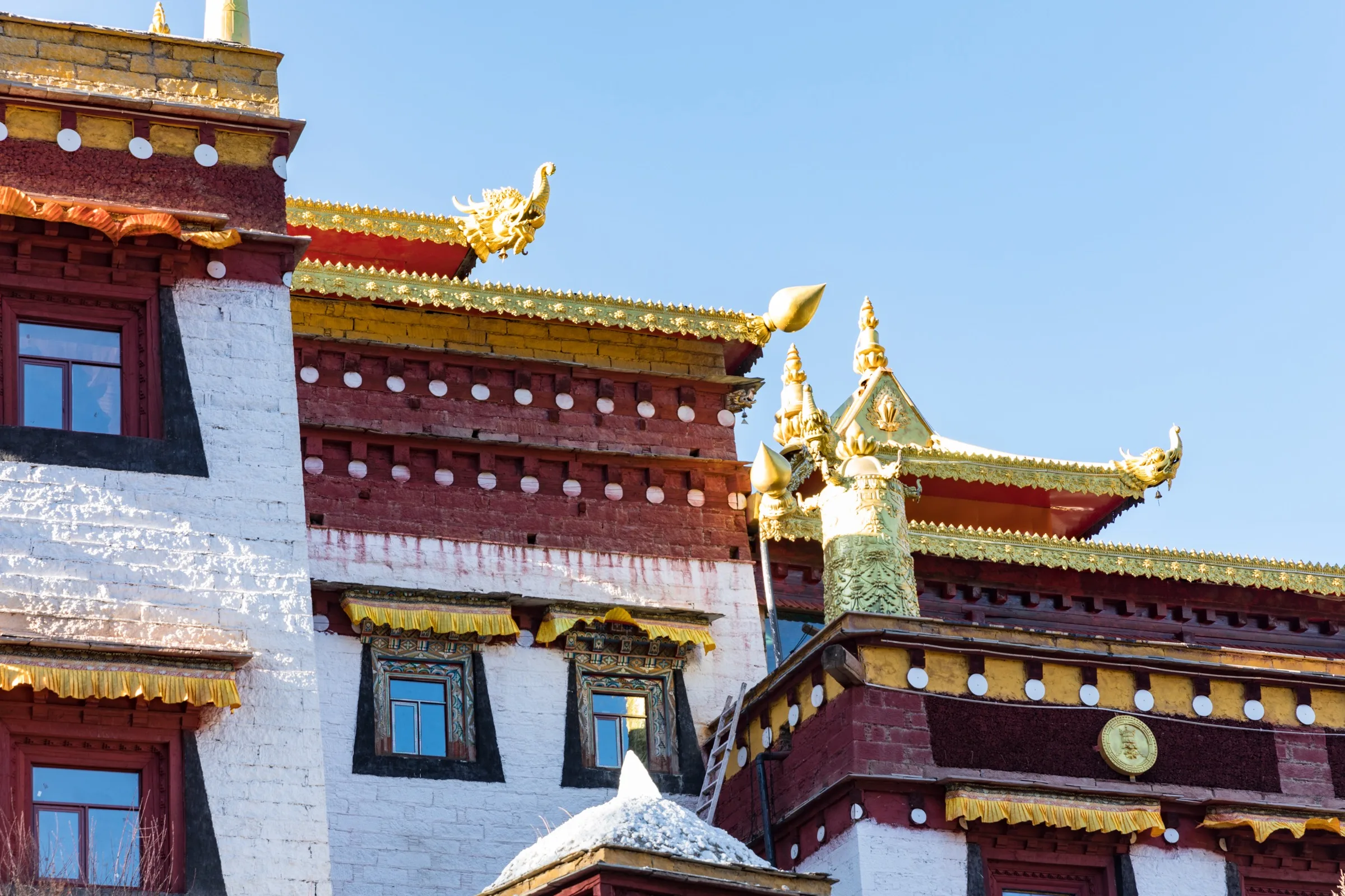 Chonggu Monastery and its red, white and gold Tibetan architecture in Daocheng Yading