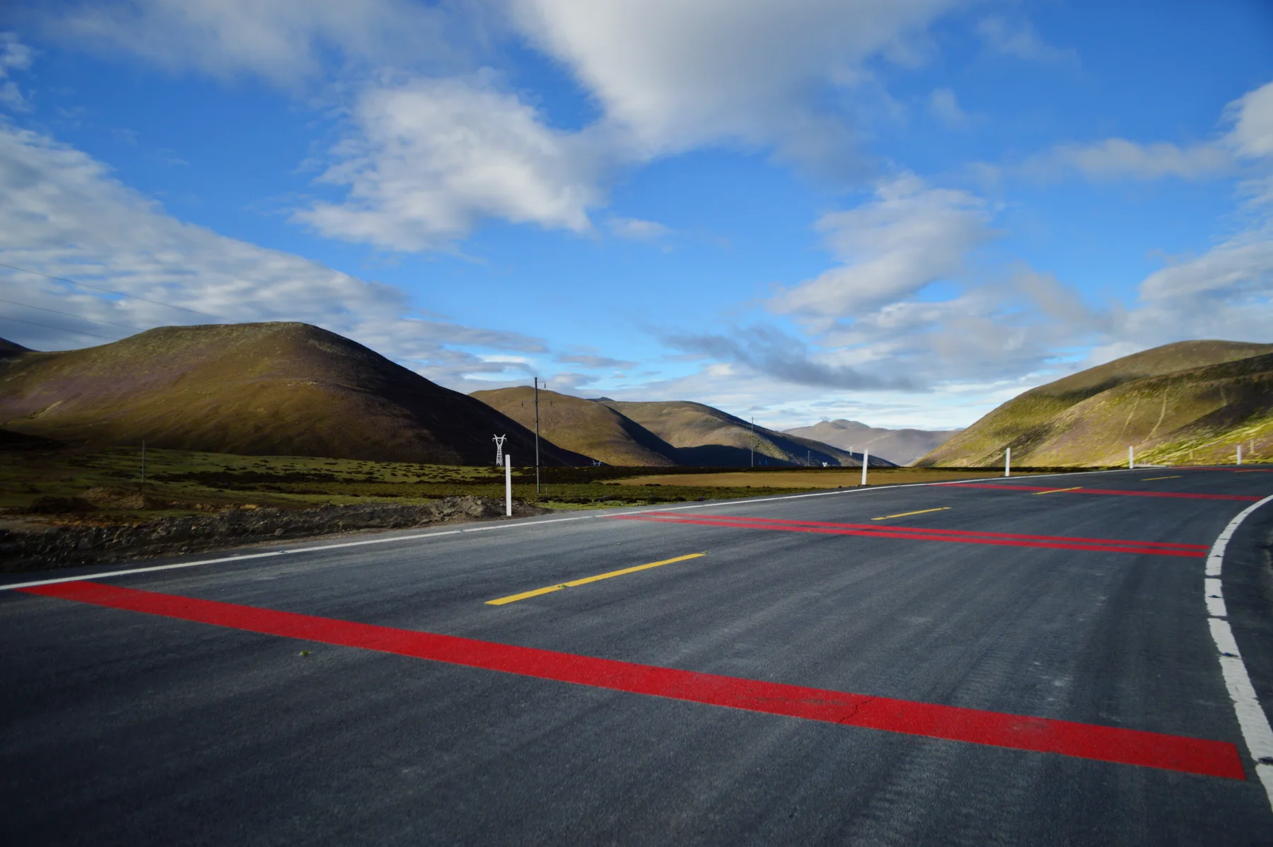 A mountain road crossing the high landscape on the journey to Daocheng Yading