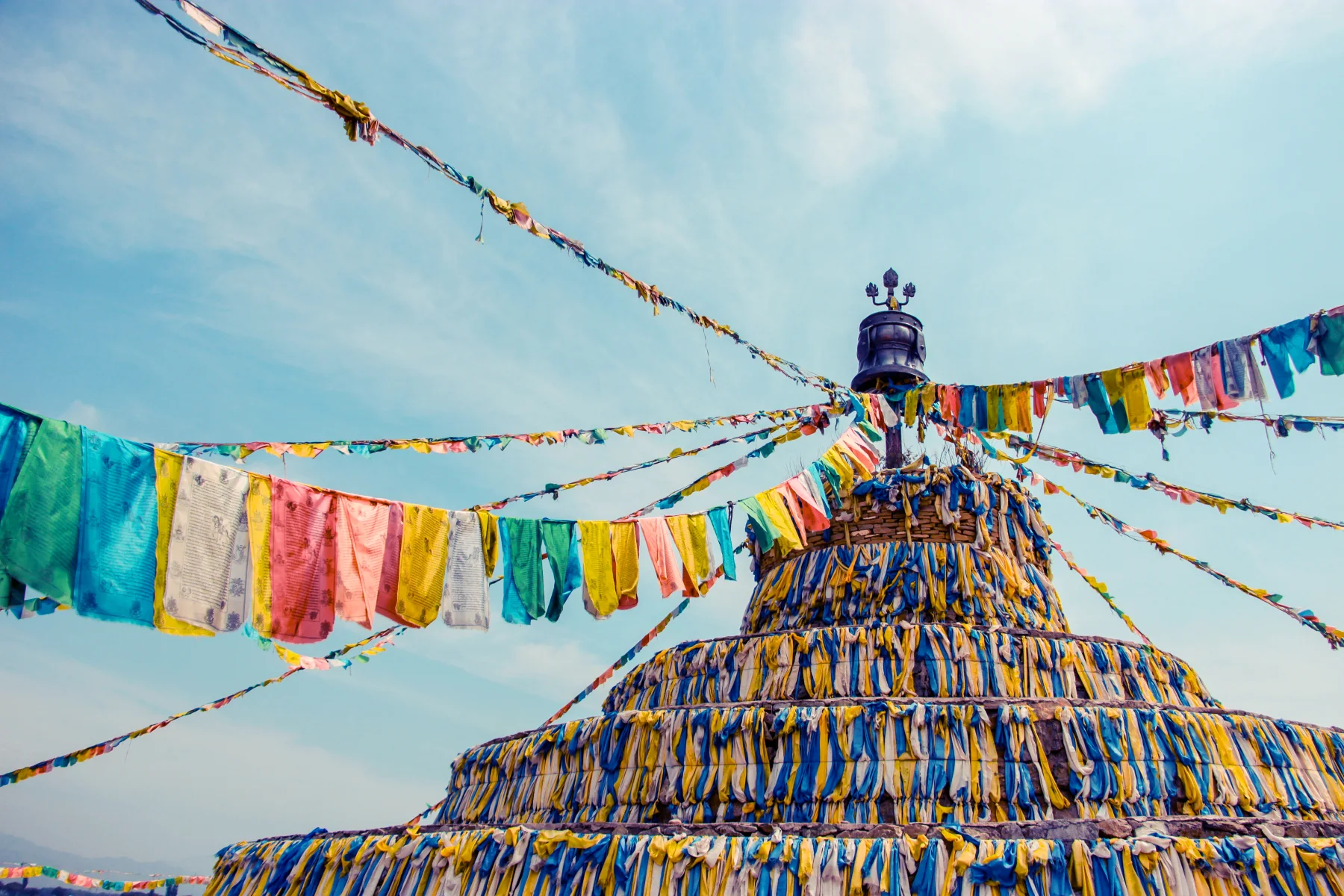 Prayer flags framing a sacred mountain landscape in Daocheng Yading