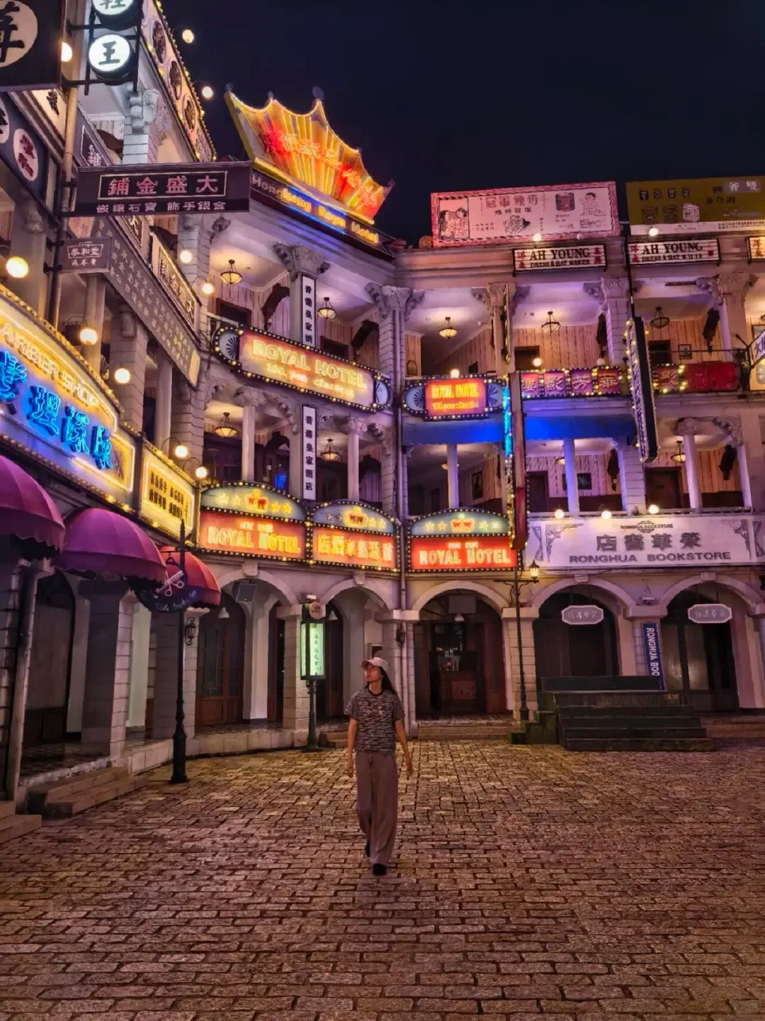 A brightly lit period street set at night in Hengdian
