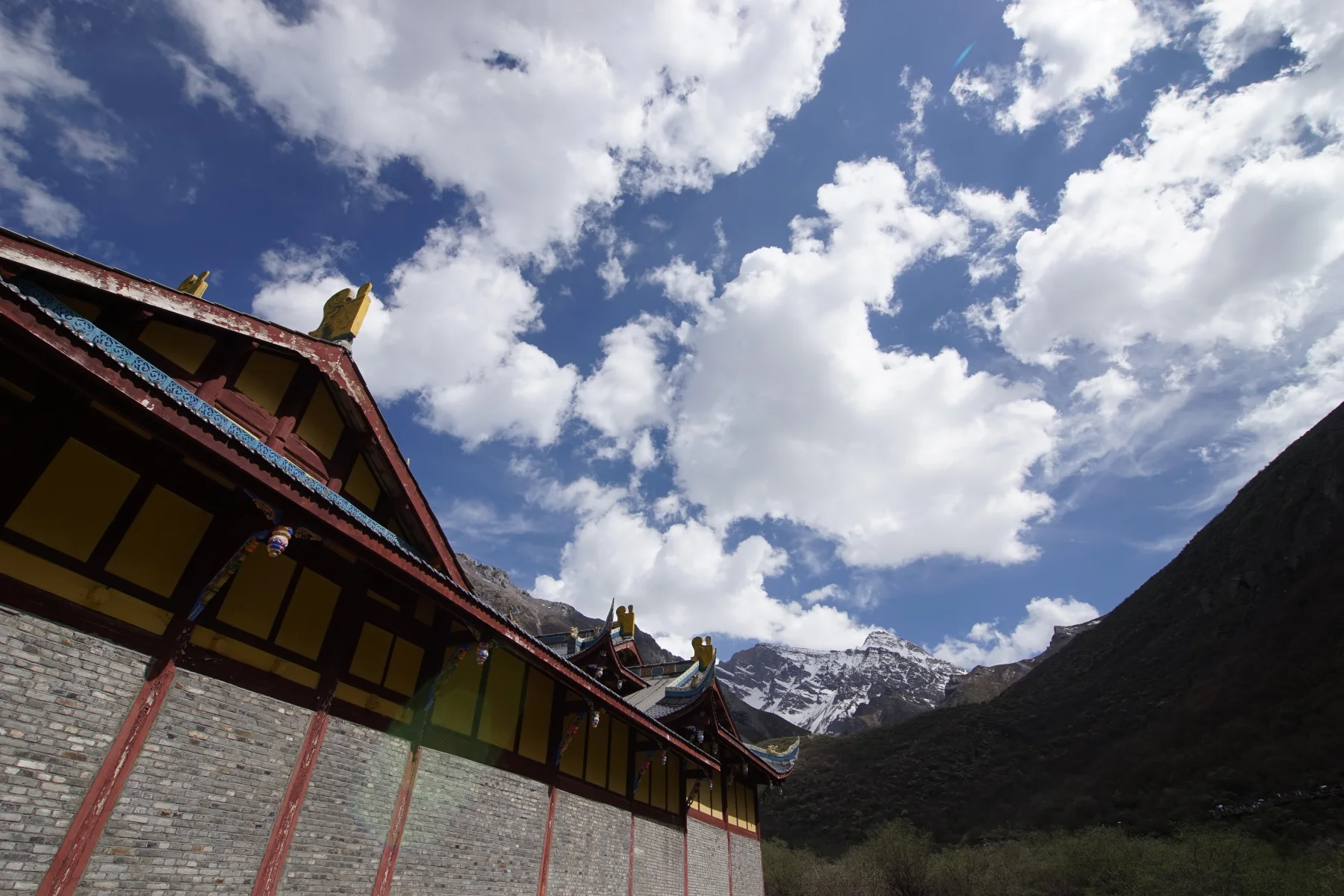 Tibetan-style building set within Jiuzhaigou's mountain landscape