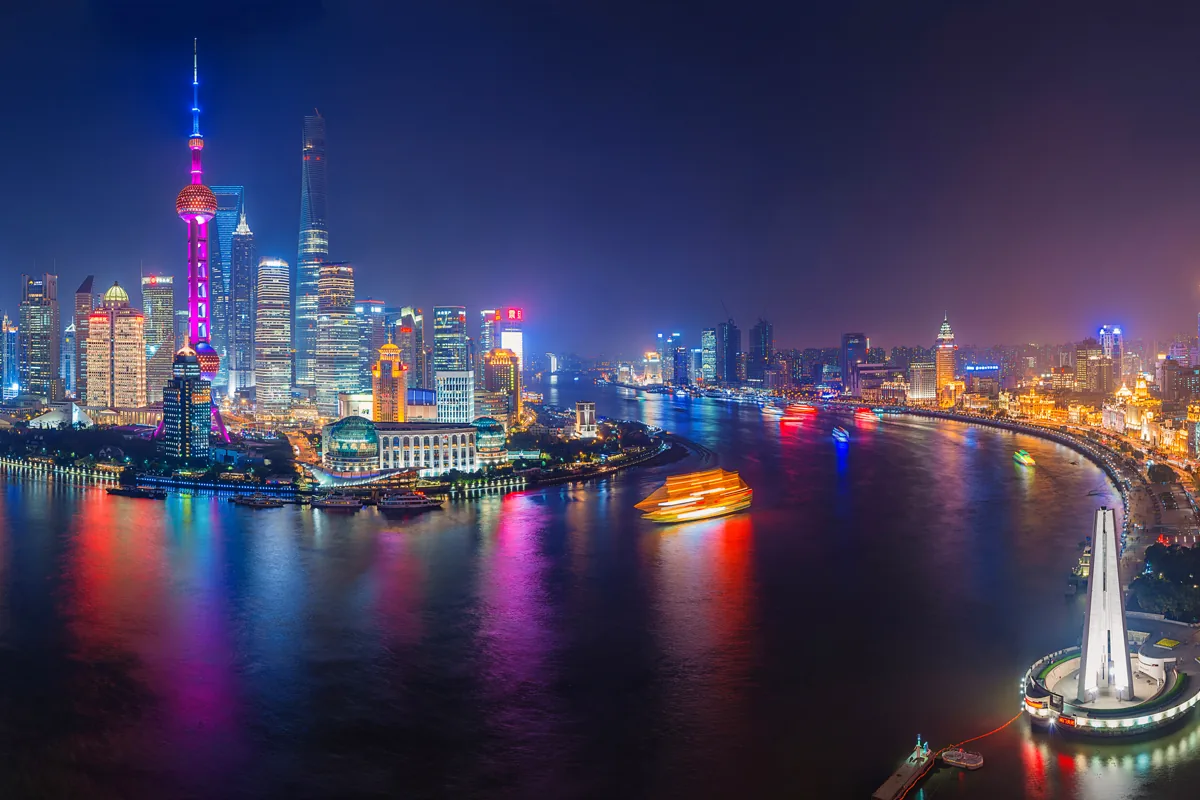 Shanghai Bund and Pudong skyline illuminated during nighttime travel to China